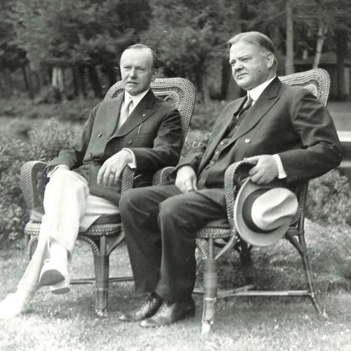 Levi Pennington and Herbert Hoover sitting on lawn chairs