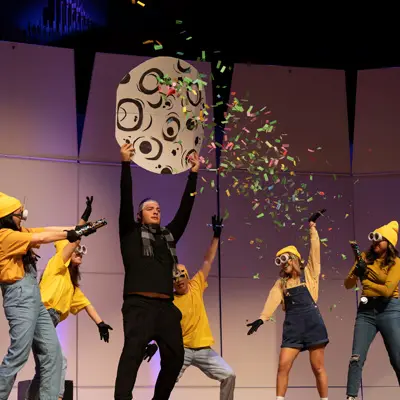 Students reenact Dispicable ME on stage dressed as minions for LipSync