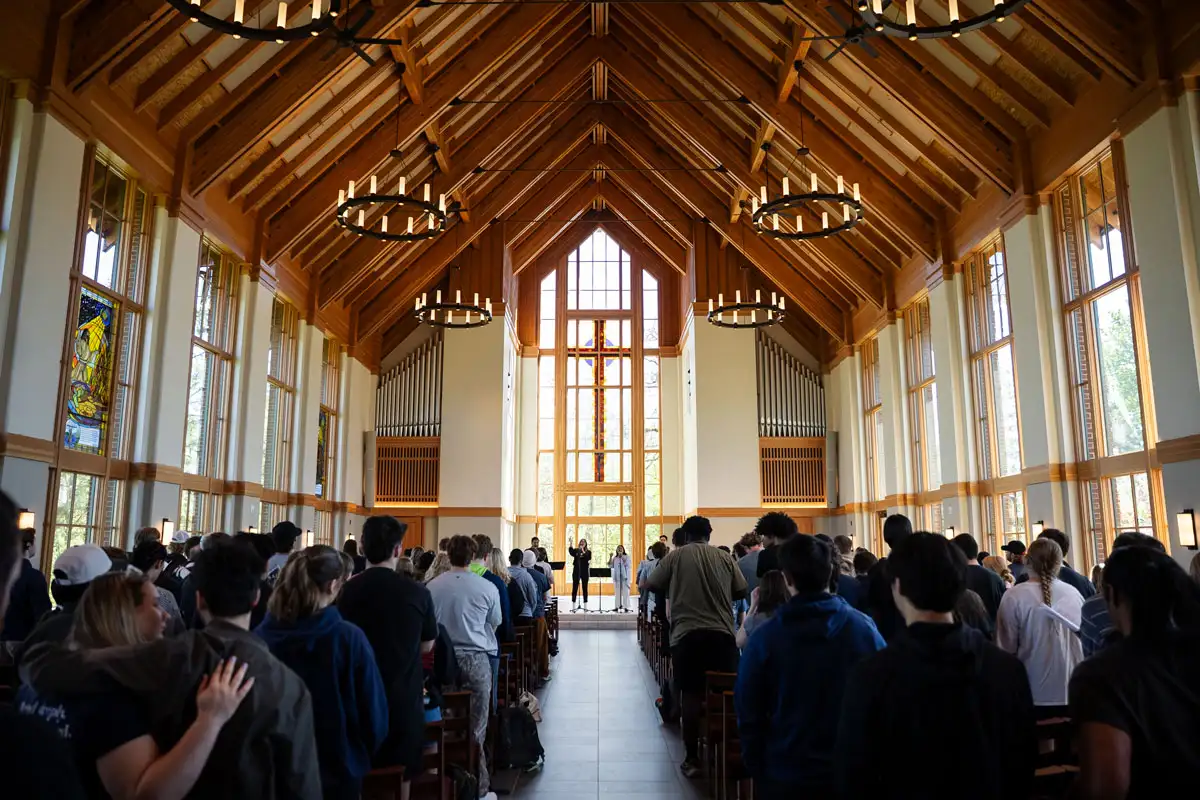A picture of students worshiping in the chapel