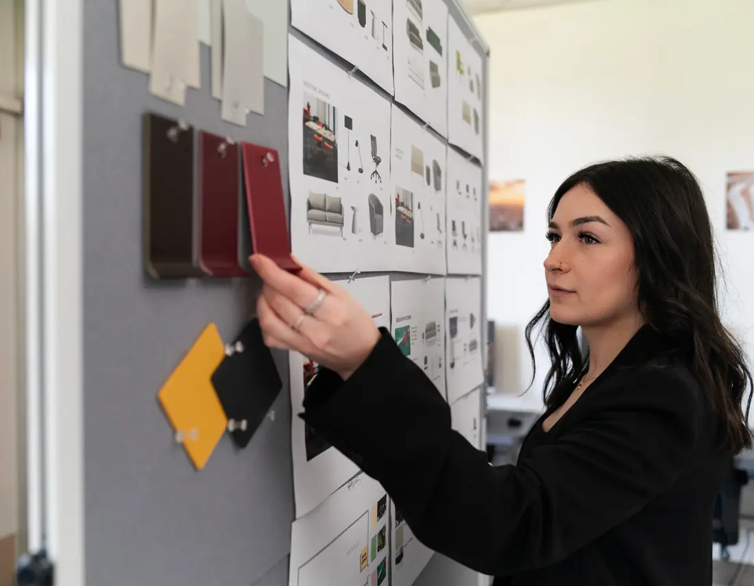 Student looks through samples on an interactive board in the studio