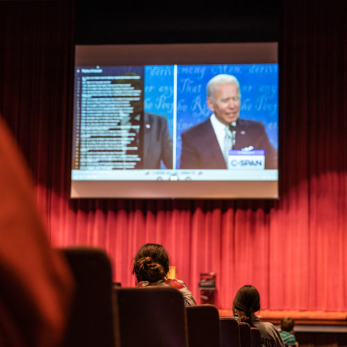 student in auditorium for election