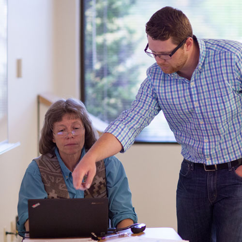 counselor helps older student with computer