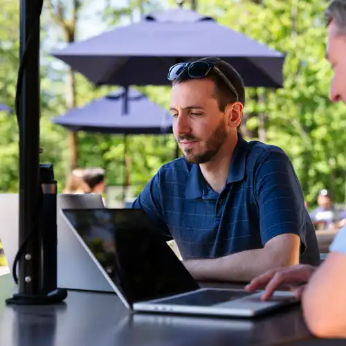 Man working on school on his laptop outside