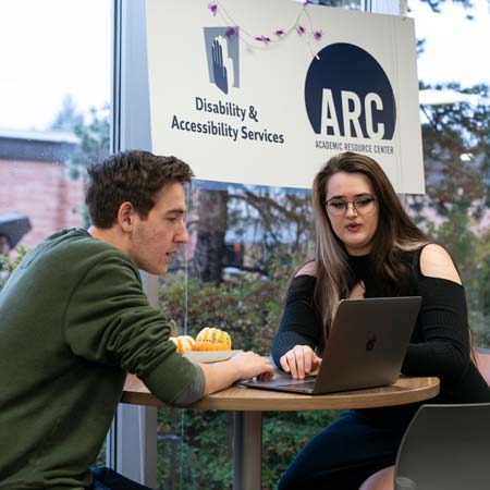 An ARC consultant helping a student