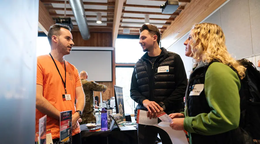 Students talk to a professional at the career fair