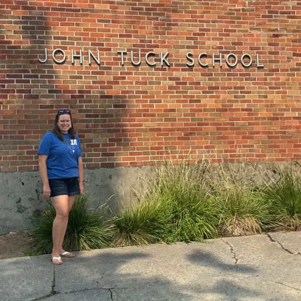 Katelyn stands outside of her school