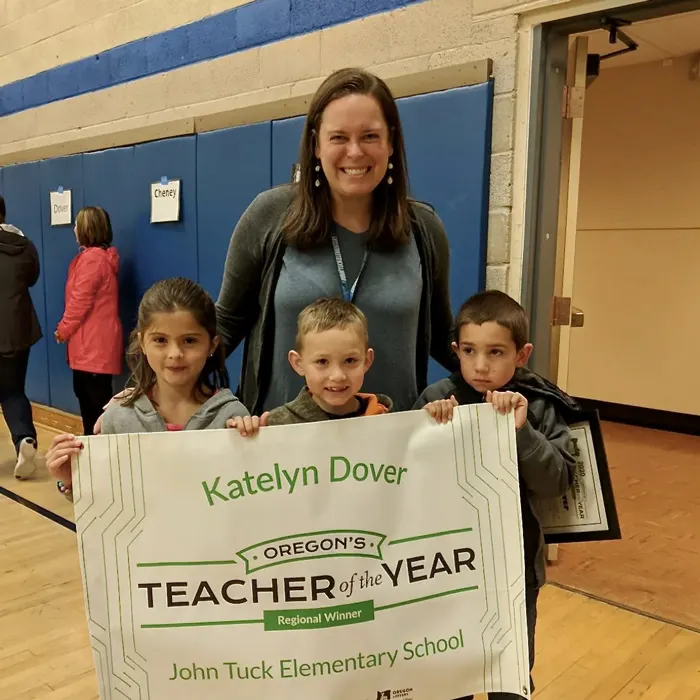 Katelyn Dover smiles with children