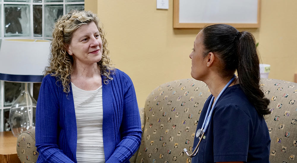 Pam Fifer talking to a student