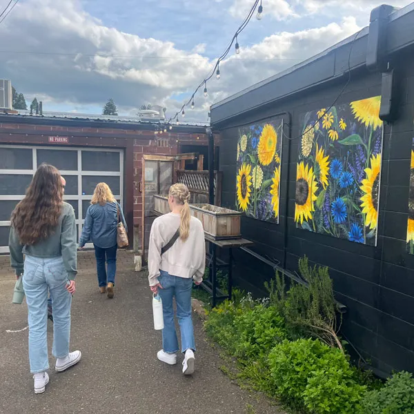 students walk outside the Lemon and Olive restaurant, which is tucked in an alley