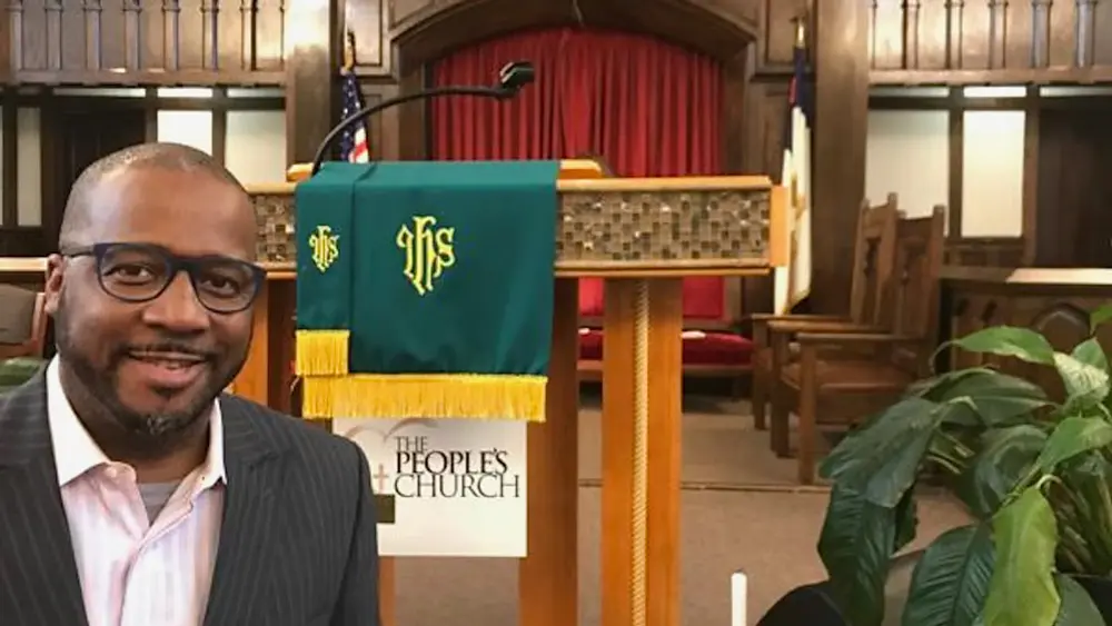 Daren Jaime taking a selfie in front of the pulpit at People’s African Methodist Episcopal Zion Church where he is the lead pastor
