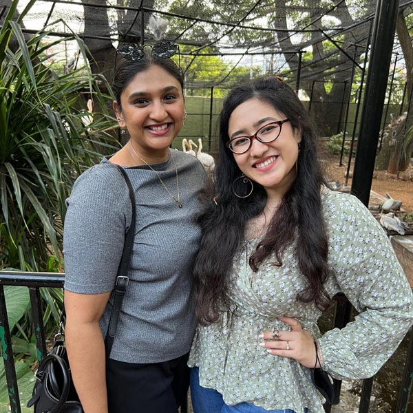 Rachel standing smiling with a friend at some outdoor excursion