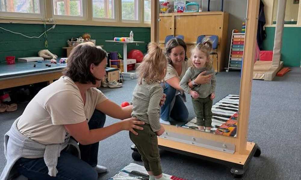 Kayla Taylor providing physical therapy for a child