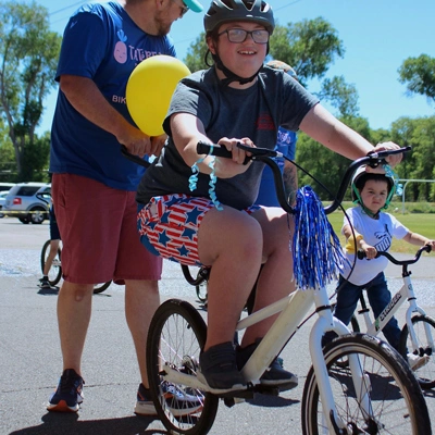 Boy learning to ride a bike at Tater Tots Pediatric Therapy