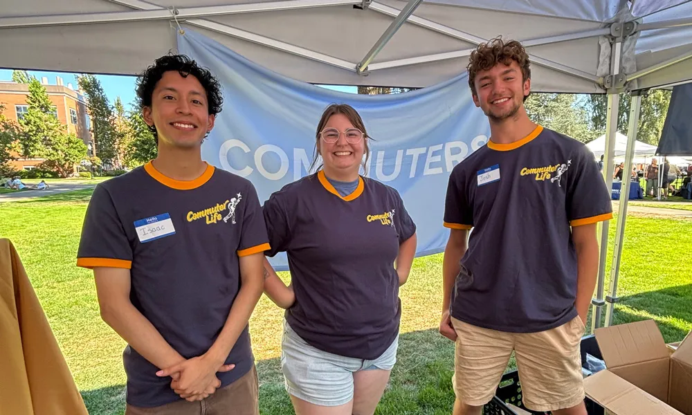 Commuter life staff smiling at a booth