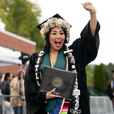 Student celebrating with their diploma