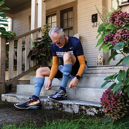 President Robin Baker tieing his running shoes
