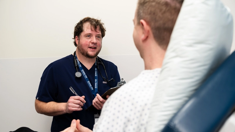 Dave Wilcox talking to a patient