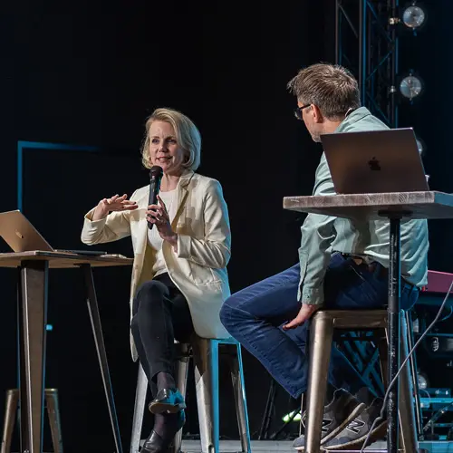 Dr. Leah Payne talks on stage