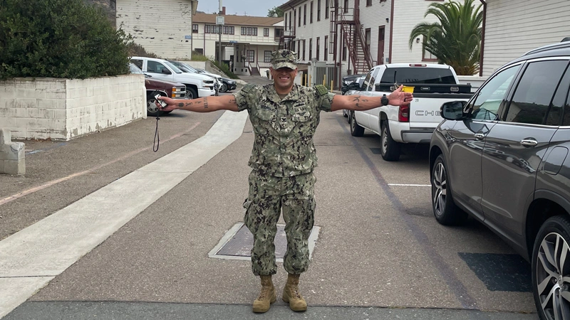 Rodriguez smiling with his arms out in uniform
