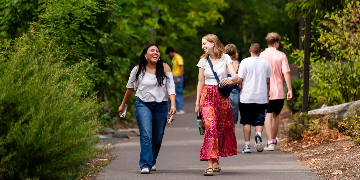 Two friends walks through campus together