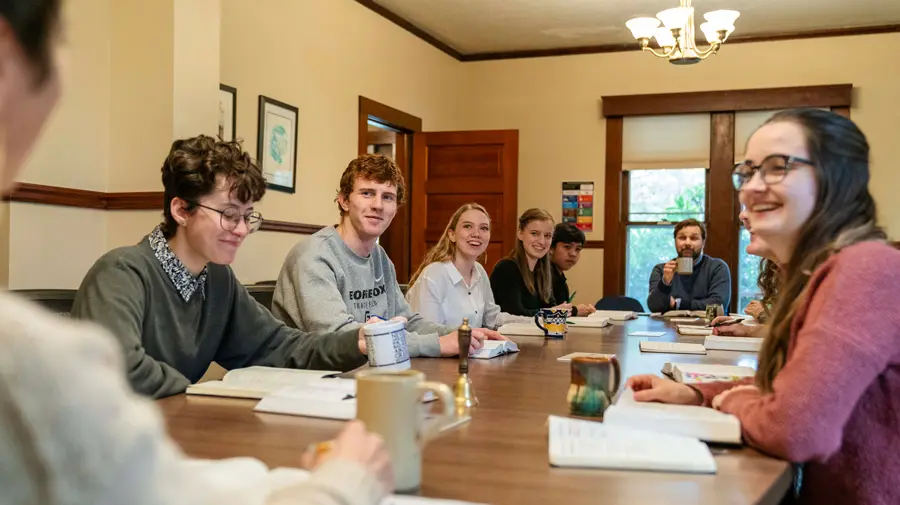 Honors students learn around a large table