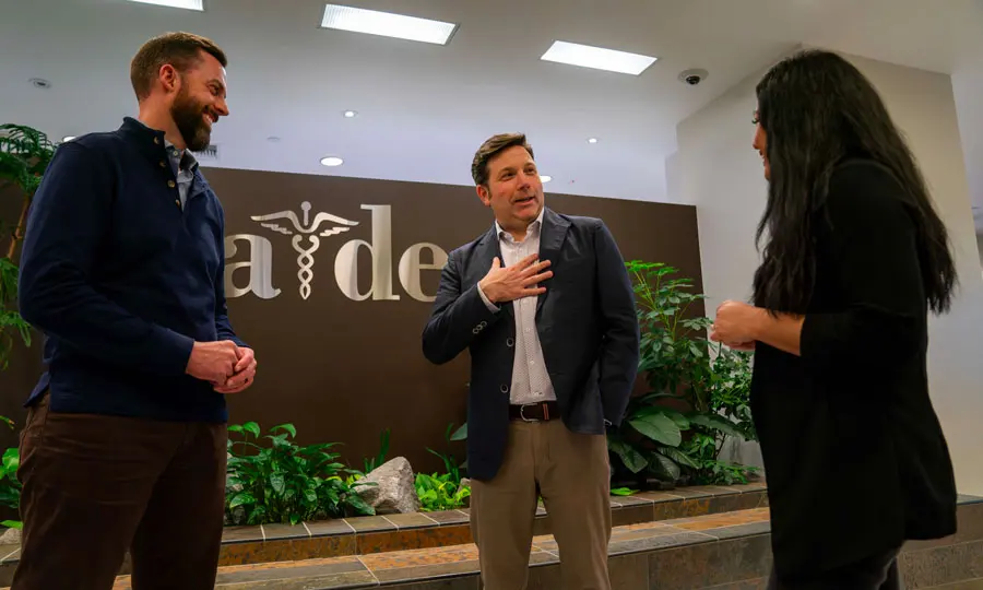 Three business professionals having a discussion at A-DEC