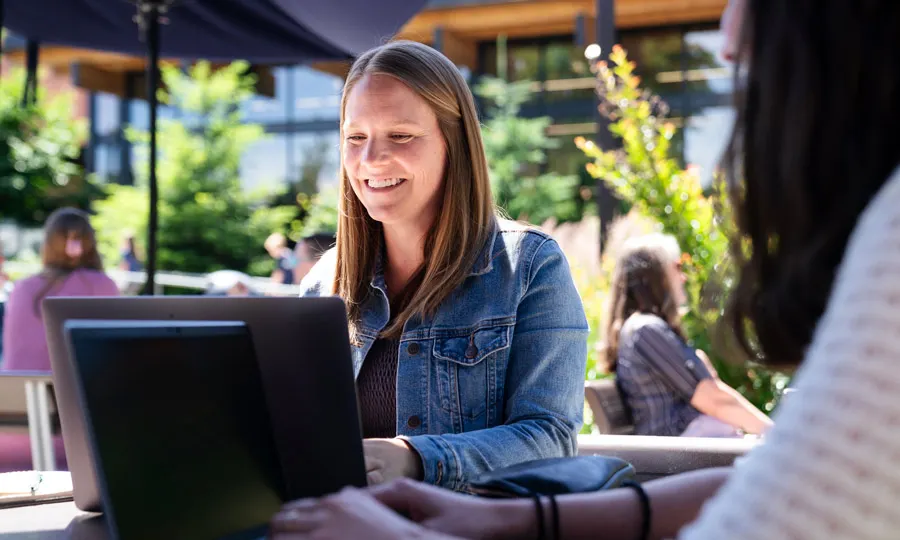 A student taking classes online, sitting outside