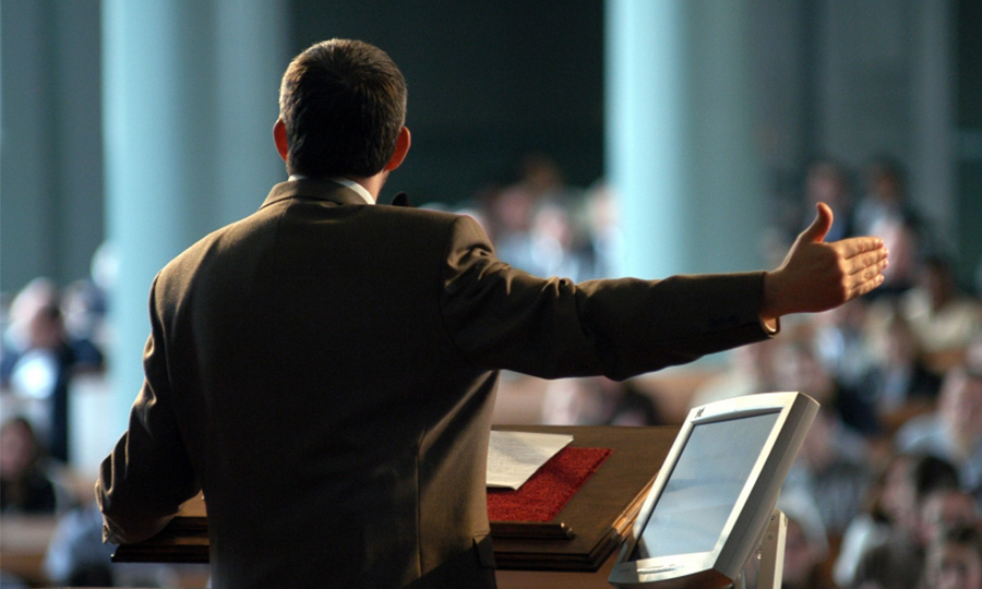 A business professional giving a presentation at the podium