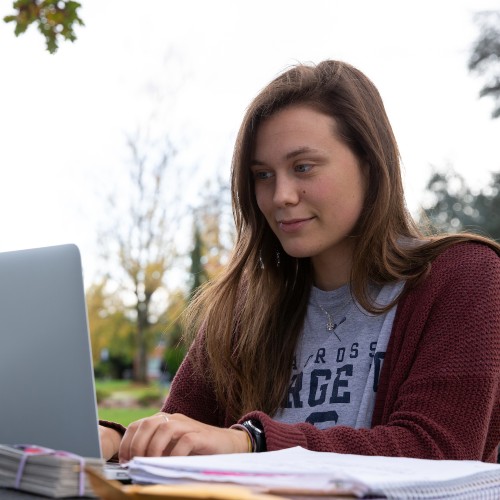College student on a laptop computer outdoors