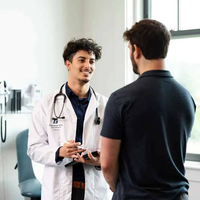 A osteopathic doctor speaks with a patient