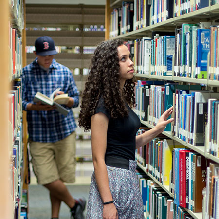 Students looking for resources and books in the library