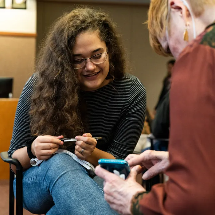 Student talks with an older person