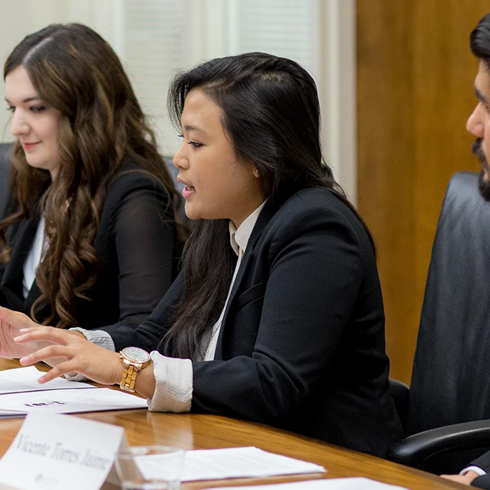 Student at a conference table