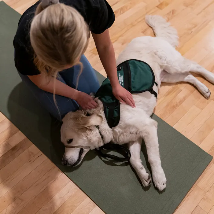 Student holds a dog