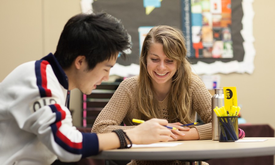 One student helping another student with homework