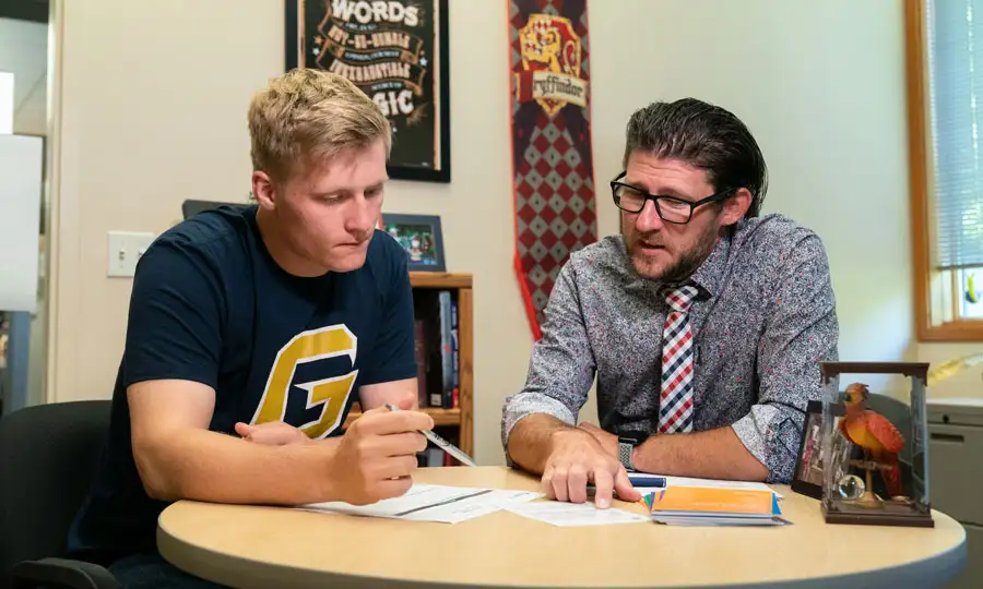 CAP coach explaining something and working through something with a student