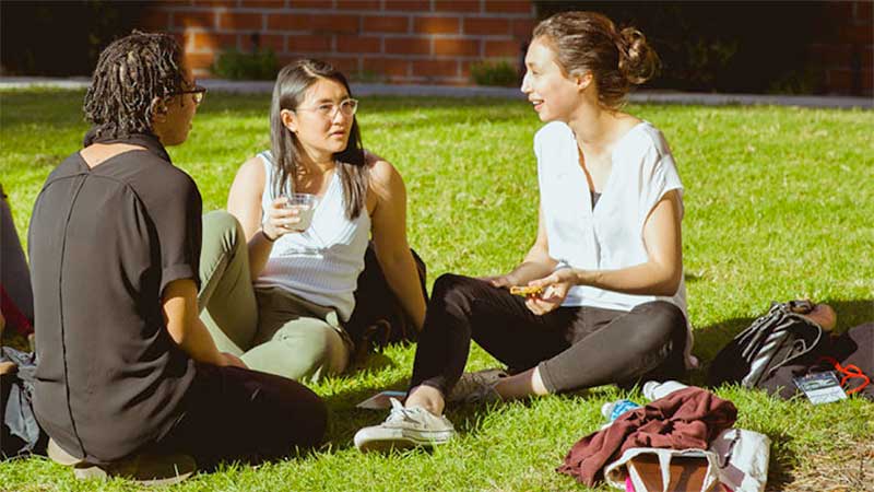 Students attending the SCORR conference sitting on the grass