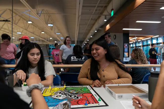 Students laughing playing the board game Sorry in Hadlock