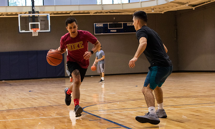 Students playing basketball in the gym