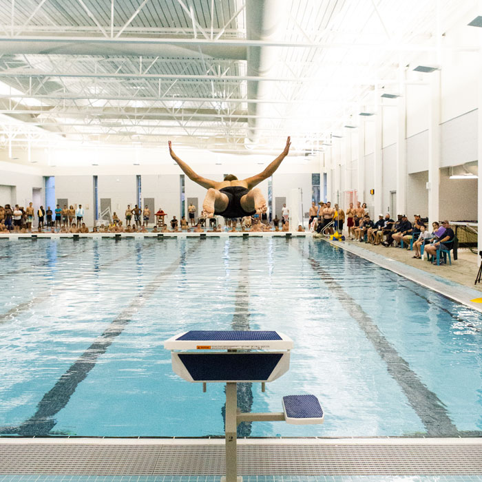 Student dives into pool