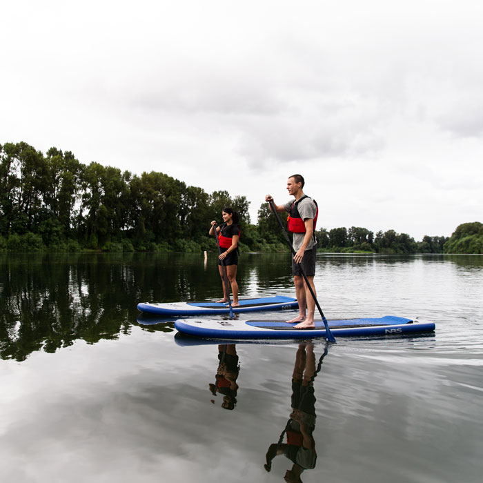 Students paddle boarding on the river