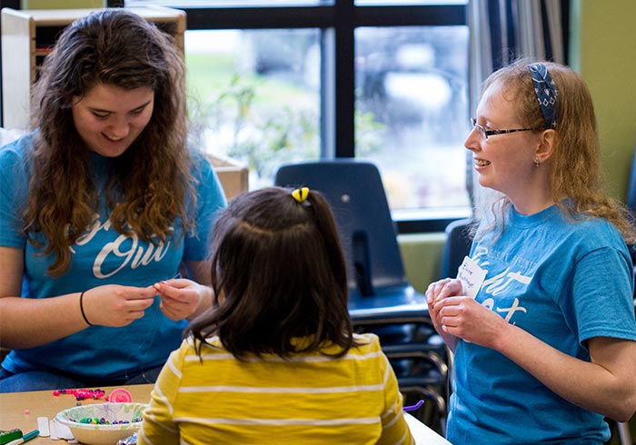 Students take care of the children during the Foster Parent Night Out