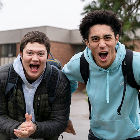 Two students showing excitement on campus