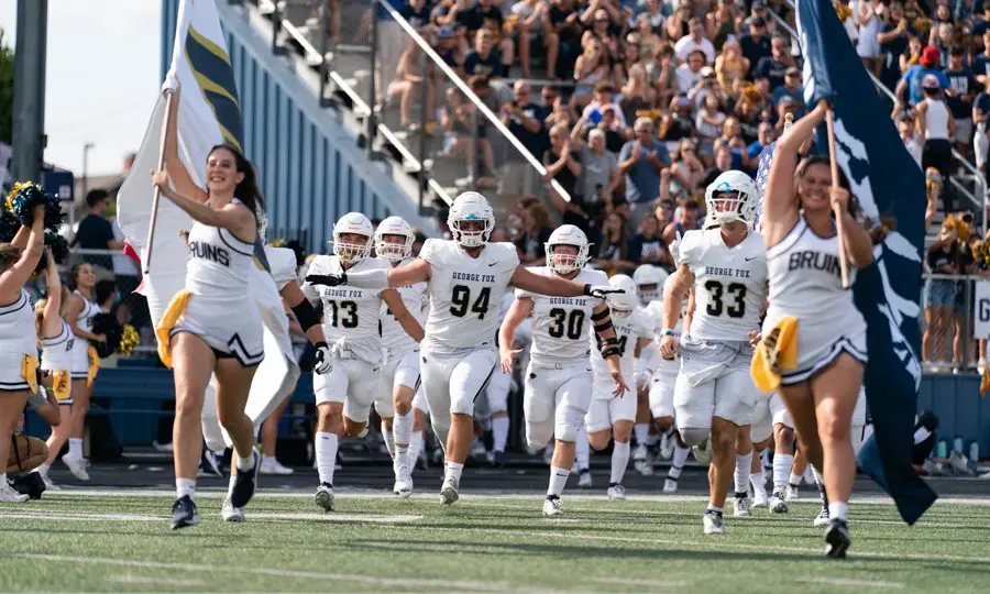 Football players running onto the field