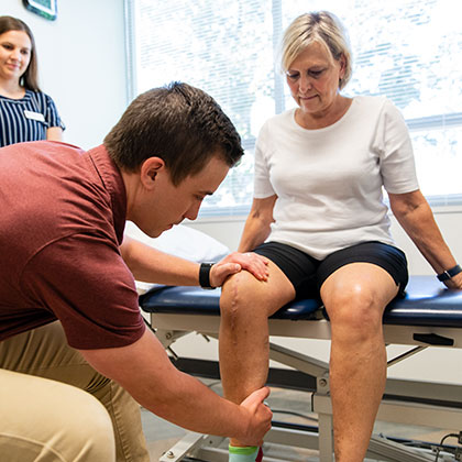A patient works with a therapist at George Fox University Physical Therapy clinic