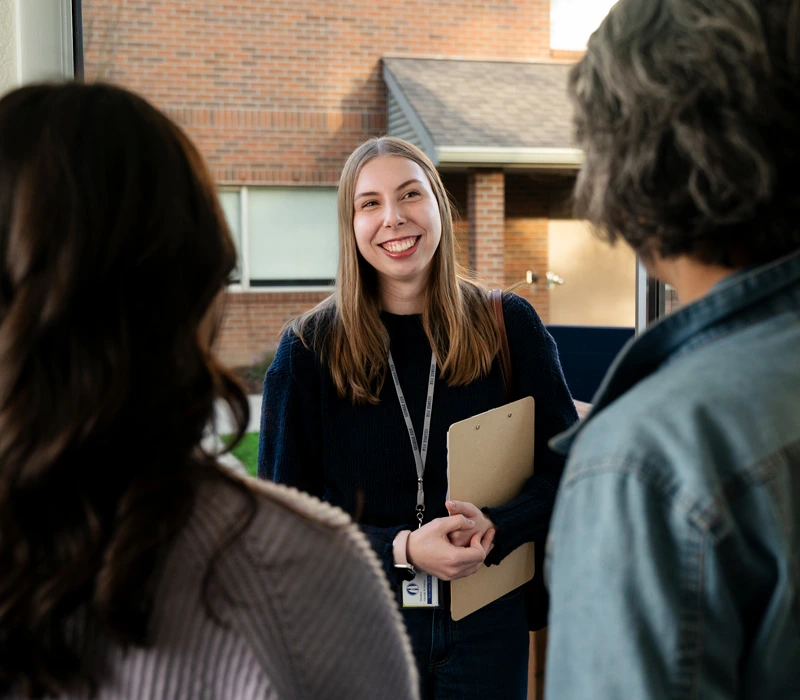 Counselor greeting a couple at their door
