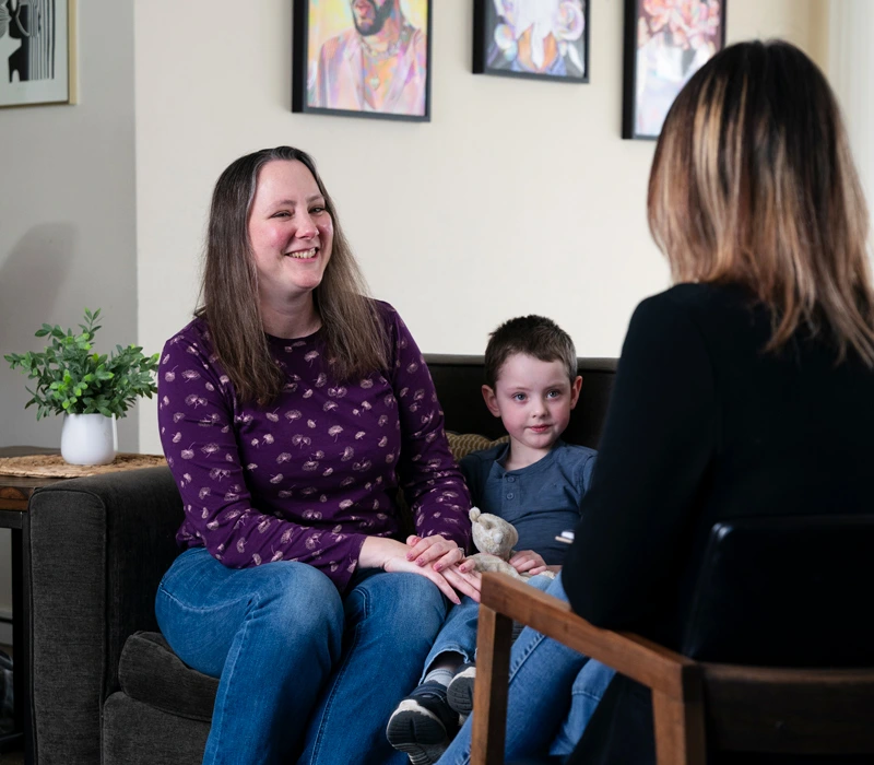 Counselor talking to a mother and son