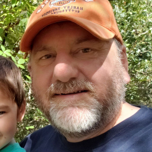 Tim in an orange hat outside.