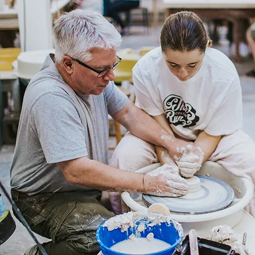 Mark Terry helping a student with ceramics