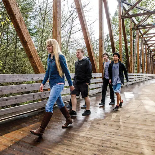Students smiling and walking across Crisman Crossing